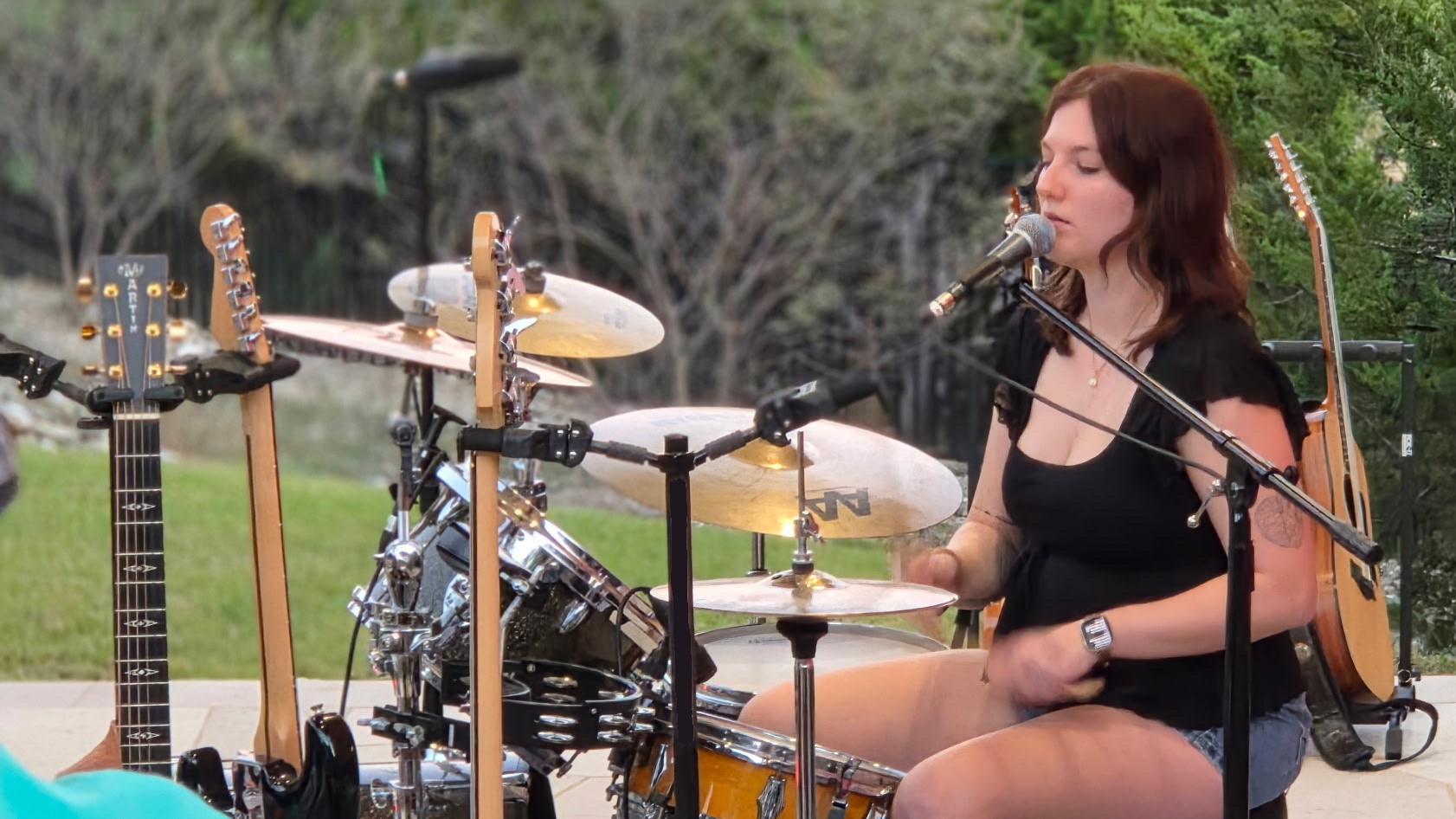 Seated girl playing the drums.